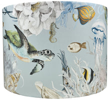 Load image into Gallery viewer, Under the sea lampshade featuring dolphins, fish, turtles, and jellyfish on a light blue background.