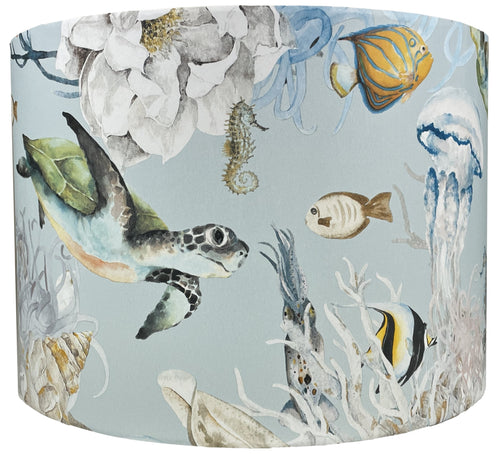 Under the sea lampshade featuring dolphins, fish, turtles, and jellyfish on a light blue background.